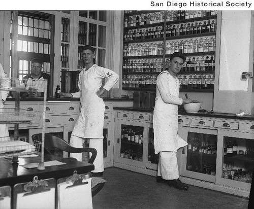 Two Pharmacist's Mates and another sailor in the pharmacy at the Naval Hospital