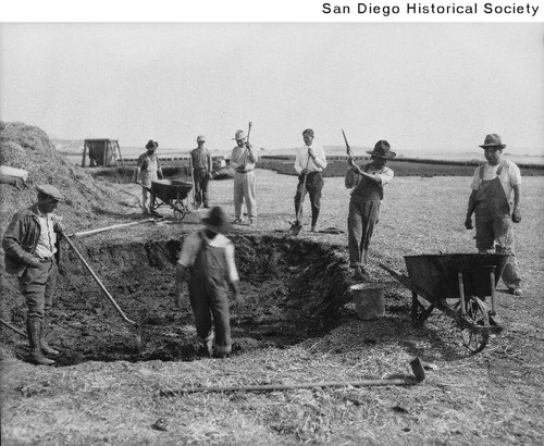 Adobe brick makers around a large mud pit used to make adobe bricks for the Shore Acres Country Club