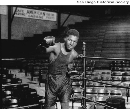 Boxer Young Harry Wills posing in the corner of a boxing ring