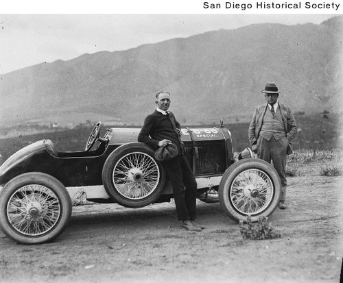 James Sterling and F.B. Naylor standing near an automobile in the mountains