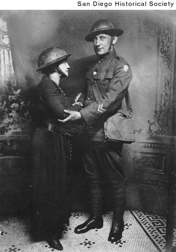 Portrait of Cody Warriner in an Army uniform with an unidentified woman wearing a military helmet