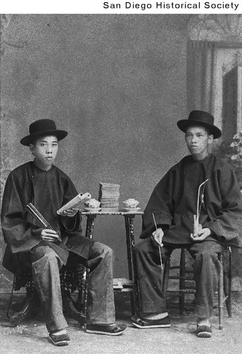 Two Chinese men seated at a table