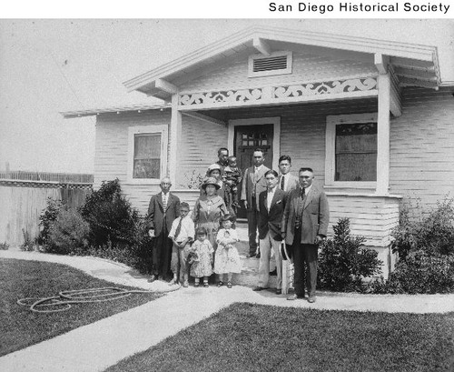 The Yamashita family standing outside the front of a house