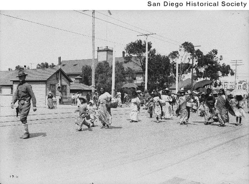 Mexican refugees, mostly women and children, being escorted by US Soldiers down a street in San Diego