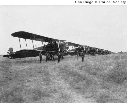 Men standing near a line of biplanes at Rockwell Field on North Island