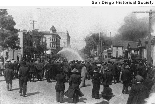 Police using a fire hose to quell unrest during the 1912 I.W.W. riot