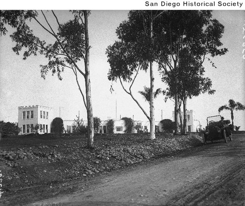 An automobile driving past eucalyptus trees and the E.W. Scripps ...