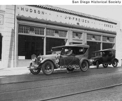 Two Hudson automobiles in front of J.W. Freiden's Hudson Essex dealership