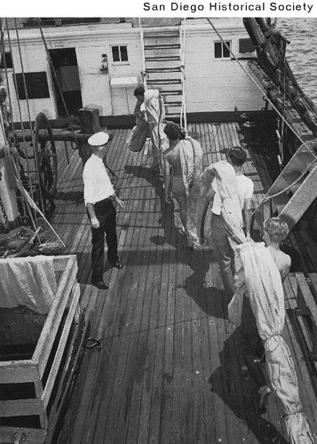 Sea Scouts carrying a sail aboard the Star of India