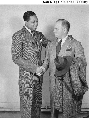 Boxing legend Archie Moore shaking hands with his manager Jack Richardson