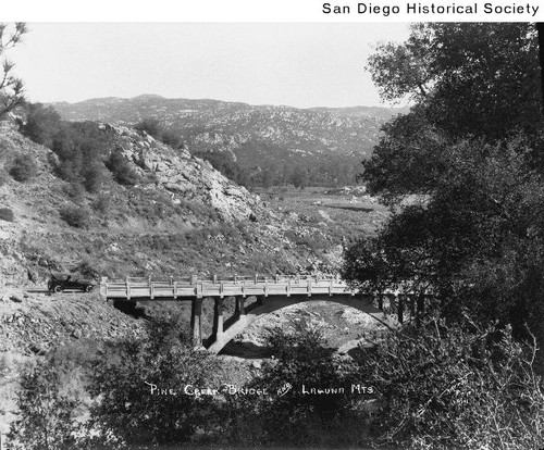 An automobile about to cross a bridge near Pine Valley