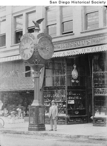 Man standing next to the Jessop Street Clock at 952 Fifth Avenue ...