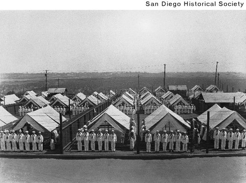 Sailors standing at attention in front of tents along Park Boulevard