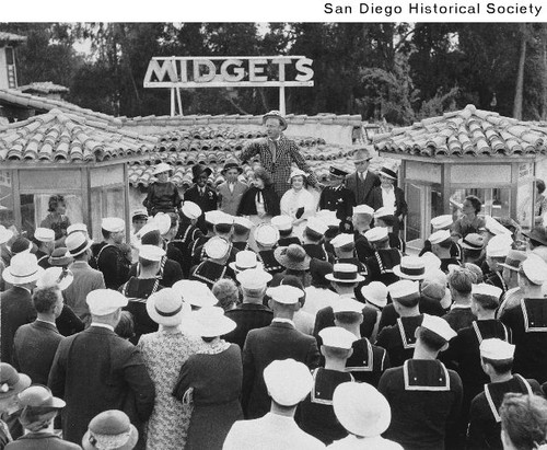 A crowd gathered to see a group of midgets at the Midget Village during the 1935 Exposition