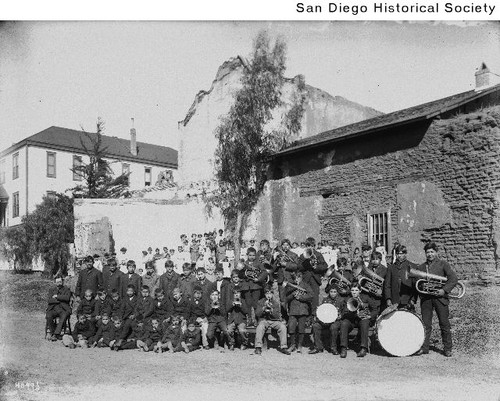 A Native American band standing near the Mission San Diego de Alcala