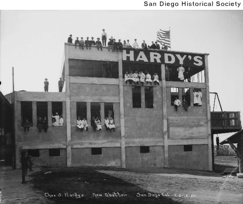 Exterior of Charles Hardy's new slaughterhouse with employees on the roof and in windows