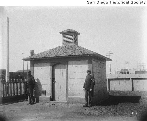 Two soldiers standing outside the brig at the Army barracks