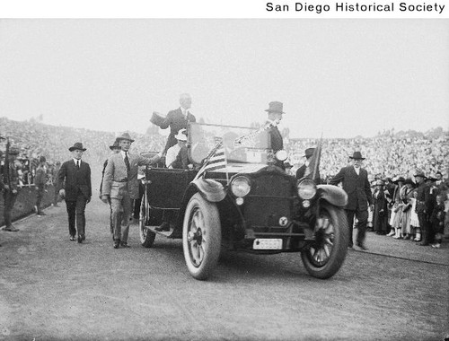 President Woodrow Wilson standing in an automobile in Balboa Stadium