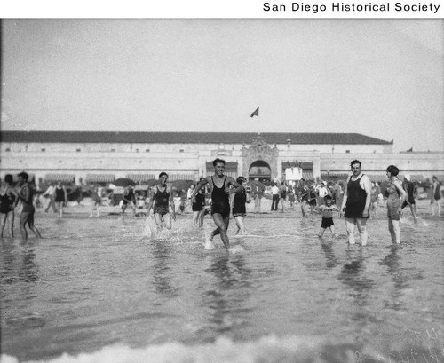 People wading in the ocean at Mission Beach