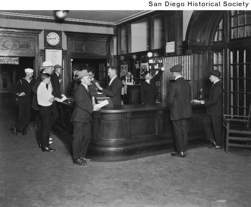 Several men at the front desk of the YMCA