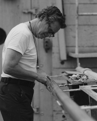 Scripps Institution of Oceanography scientist Edward L. Winterer, aboard the D/V Glomar Challenger (ship) inspecting a core during the Deep Sea Drilling Project. 1981