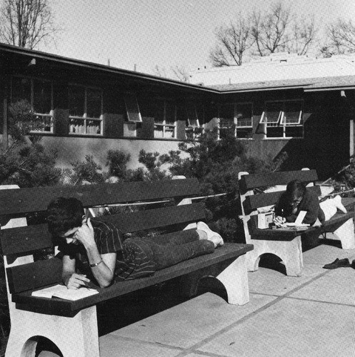 Students on benches in front of the dorms