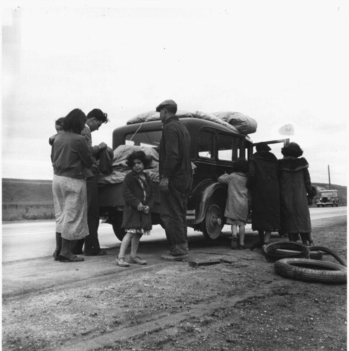 Migrant family of Mexicans on the road with car trouble, February, 1936