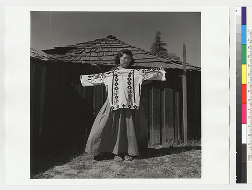 Essie Parrish holding costume; white decorated shirt, front