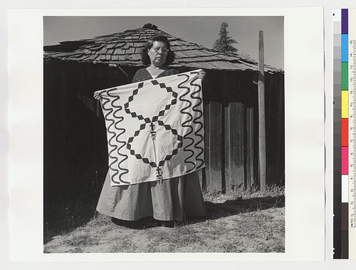 Essie Parrish holding costume; square costume piece, 3 x 3 ft