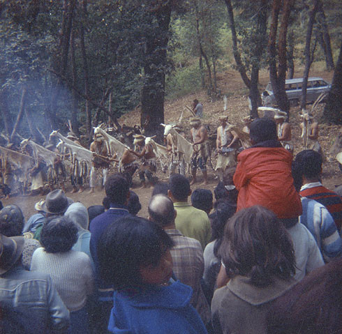 White deerskin dance with onlookers; display of large obsidian blades