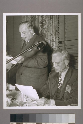 [Amadeo Peter Giannini] pledging the bank to all-out-defense aid (Gov. Olson at table)