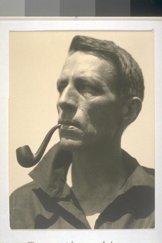 [Portrait of Robinson Jeffers with pipe.]