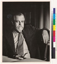 [Alfred L. Kroeber seated at desk, holding pipe.]