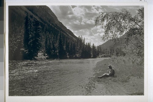 [George Rippey Stewart sitting by the] Boulder River