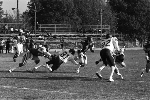Crenshaw High School football players in action on the field, Los Angeles, 1982