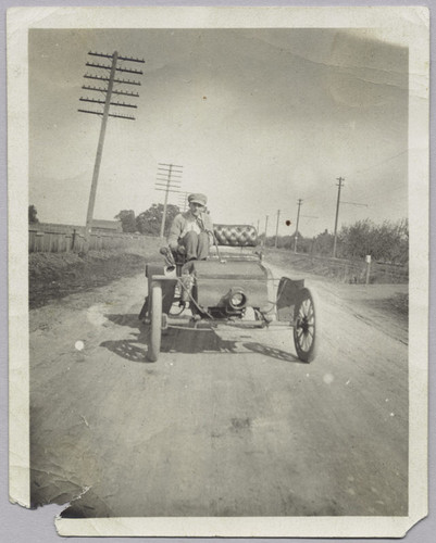 Charles Baer in 1903 Olds in front of present Sears Roebuck Co., 1908