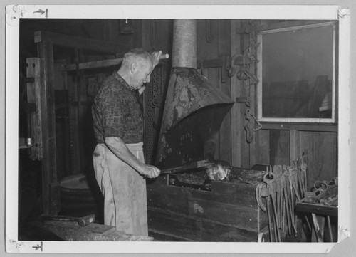 Charlie Baer in Blacksmith Shop, 1960