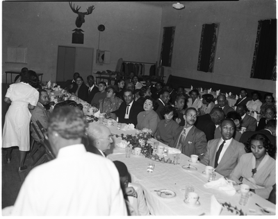 Men and women seated at dining tables