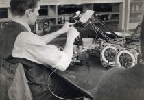Man assembling radios, Motorola factory