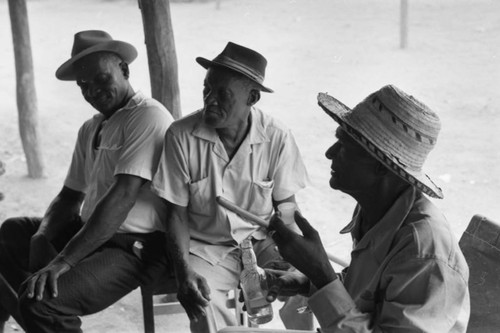 Men sit outdoors, San Basilio de Palenque, 1977