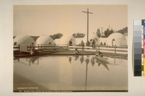 Esquimaux [Eskimo] Village, miniature lake with Canoes in Foreground, Cal. Midwinter Fair