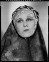 Peggy Hamilton modeling a headband with braided pearls and a veil, 1931