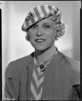 Peggy Hamilton modeling a striped cap with a matching dress, circa 1933