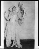 Peggy Hamilton modeling a tulle dress with matching hat and parasol, 1930