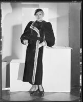 Peggy Hamilton modeling a sealskin coat trimmed in ermine, 1933