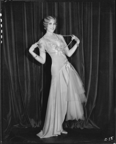 Peggy Hamilton modeling a dance frock decorated with bugle beads and rhinestones, 1930