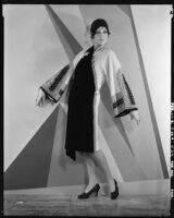 Peggy Hamilton modeling an Adrian coat in black chiffon velvet and cream broadcloth, 1929