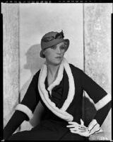 Peggy Hamilton modeling a dark colored dress or coat with light fur trim, circa 1931