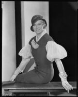 Peggy Hamilton modeling a fitted dress, a hat and embroidered gloves, circa 1931-1933