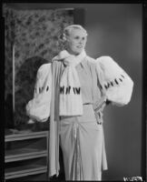 Peggy Hamilton modeling an evening gown with wide fur sleeves, 1933